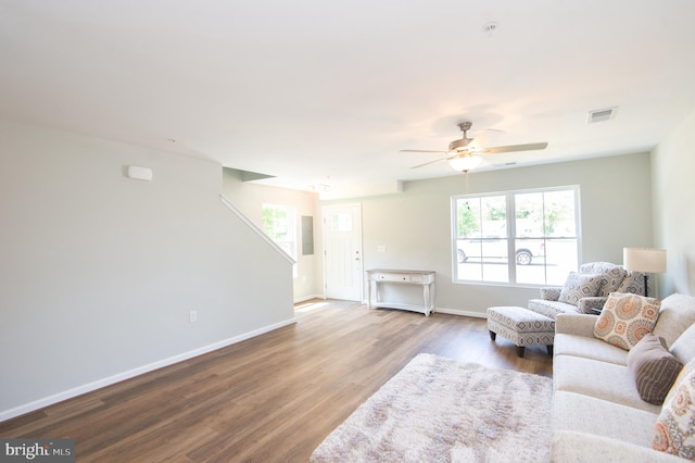 living room with wood-type flooring and ceiling fan