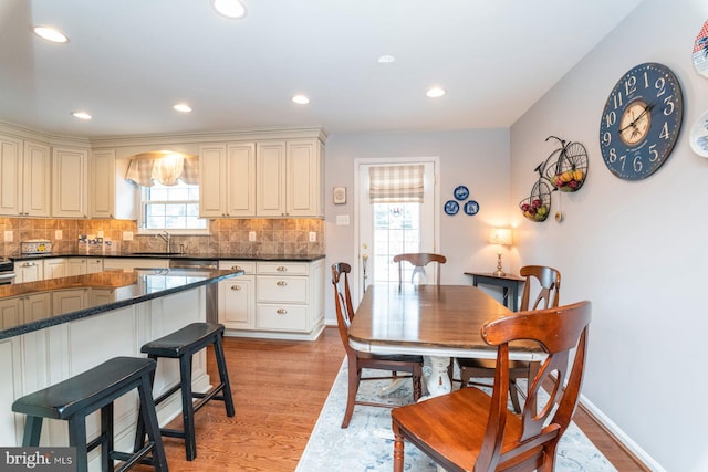 dining room featuring sink and light wood-type flooring