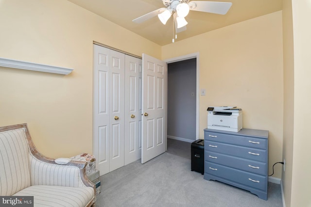 sitting room featuring ceiling fan and light colored carpet