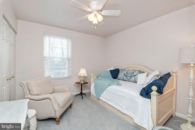 carpeted bedroom featuring ceiling fan and a closet