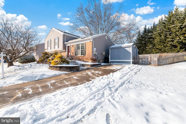 view of front of property with a storage shed