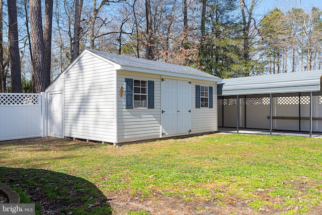 view of outdoor structure featuring a lawn and a carport