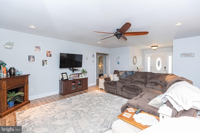 living room with ceiling fan and light hardwood / wood-style floors