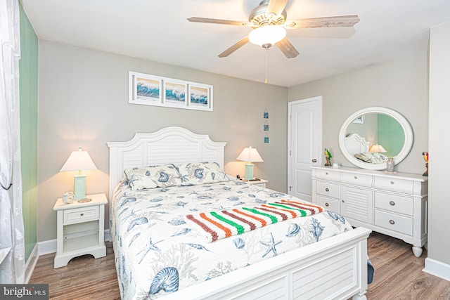 bedroom featuring ceiling fan and hardwood / wood-style flooring