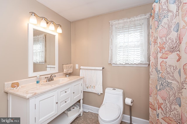 bathroom with toilet, tile patterned floors, and vanity