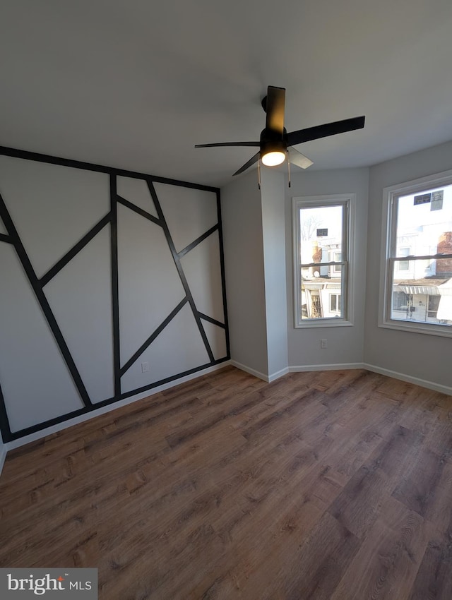 unfurnished bedroom featuring ceiling fan and dark wood-type flooring