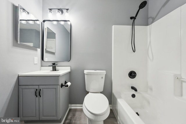 full bathroom featuring vanity, hardwood / wood-style flooring,  shower combination, and toilet