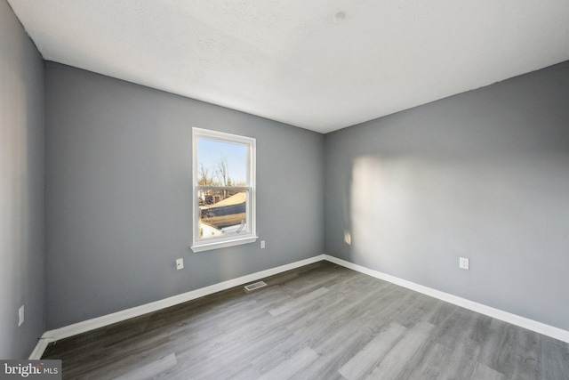 spare room featuring hardwood / wood-style flooring