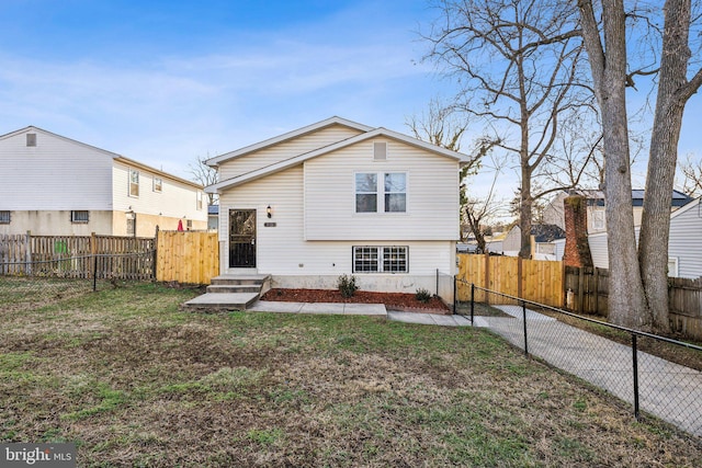 rear view of property featuring a yard