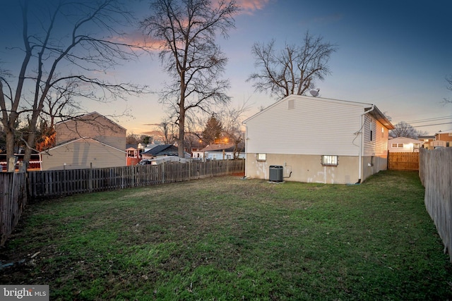 yard at dusk featuring cooling unit