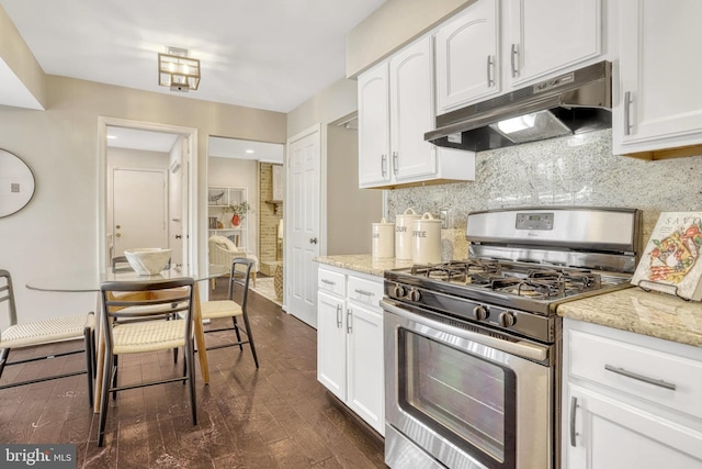 kitchen featuring white cabinetry, gas stove, and backsplash