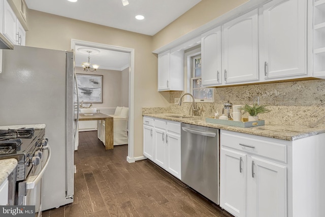 kitchen featuring light stone countertops, appliances with stainless steel finishes, sink, and white cabinets