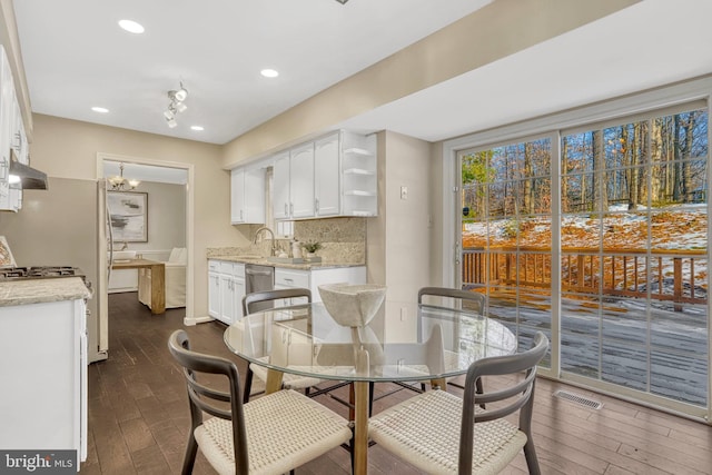 dining area with an inviting chandelier and sink