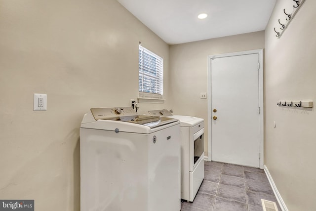 clothes washing area featuring washer and clothes dryer