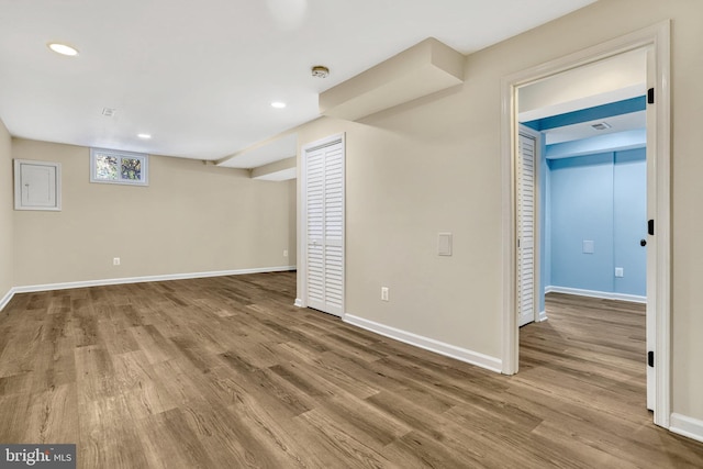 basement with hardwood / wood-style flooring