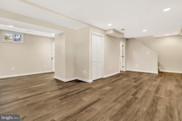 basement featuring dark hardwood / wood-style flooring