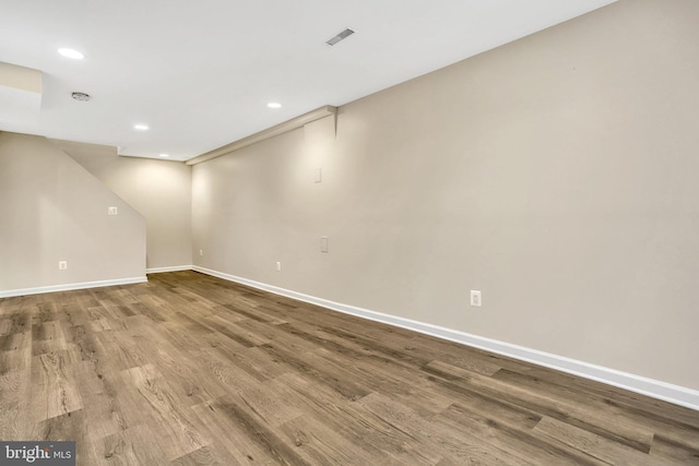 basement with hardwood / wood-style flooring