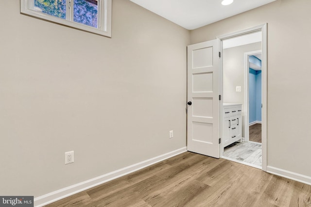 unfurnished bedroom with light wood-type flooring