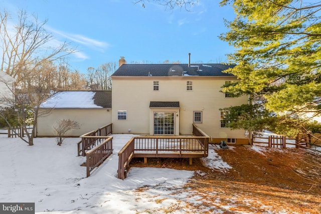 snow covered house with a deck