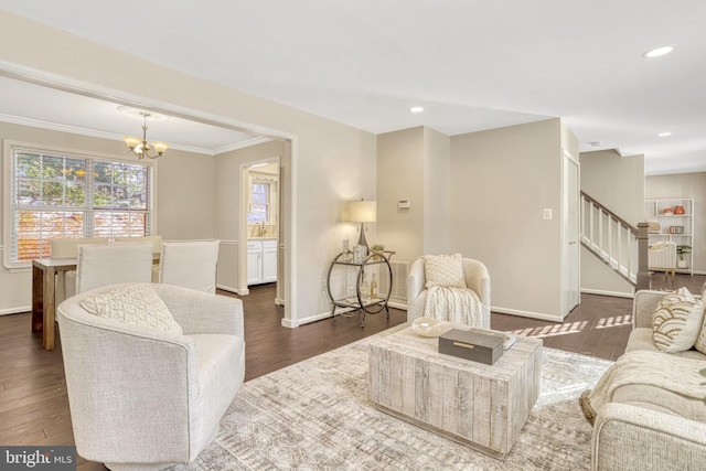 living room with ornamental molding, dark hardwood / wood-style floors, and a chandelier