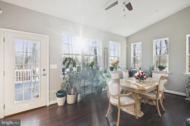 dining area with dark wood-type flooring, ceiling fan, and vaulted ceiling