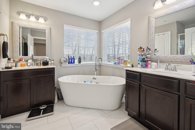 bathroom with vanity, tile patterned flooring, and shower with separate bathtub