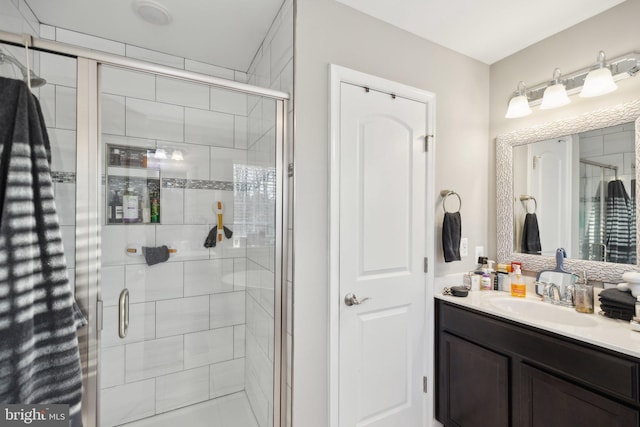 bathroom with vanity and a shower with shower door