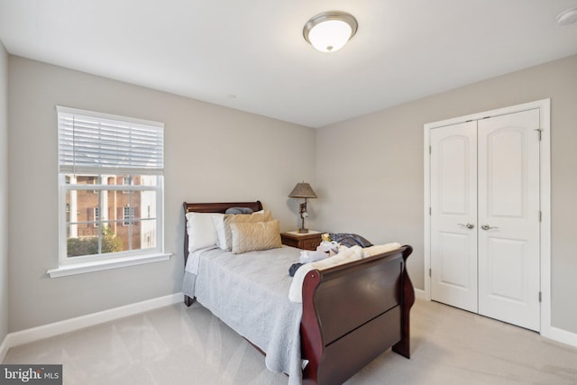 bedroom with light colored carpet and a closet