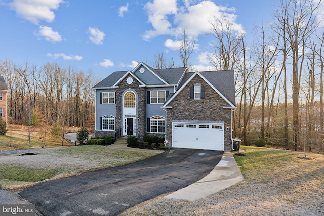 front of property featuring a garage and a front yard