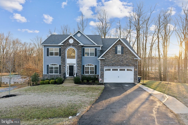 view of front of property with a garage and a front lawn