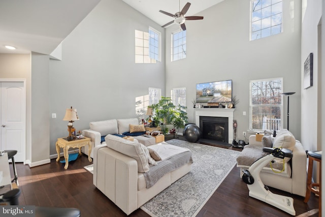 living room featuring dark hardwood / wood-style flooring and ceiling fan