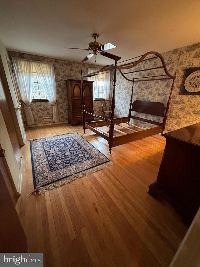 unfurnished bedroom featuring ceiling fan and hardwood / wood-style flooring