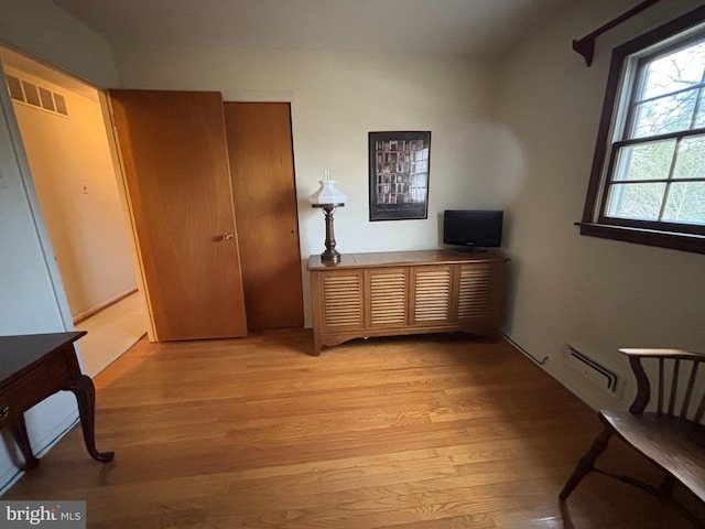 interior space with baseboard heating and light wood-type flooring