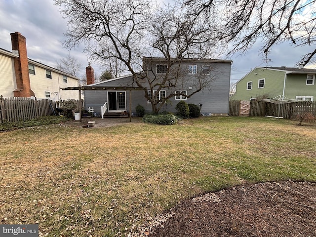 back of house with a yard and a patio area