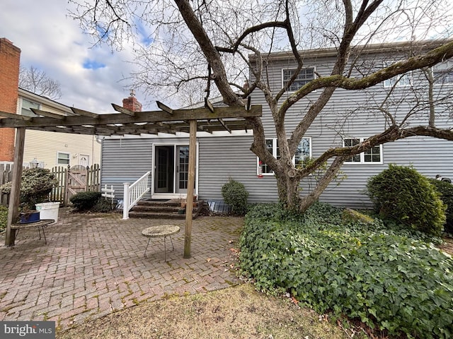 rear view of property featuring a patio area and a pergola