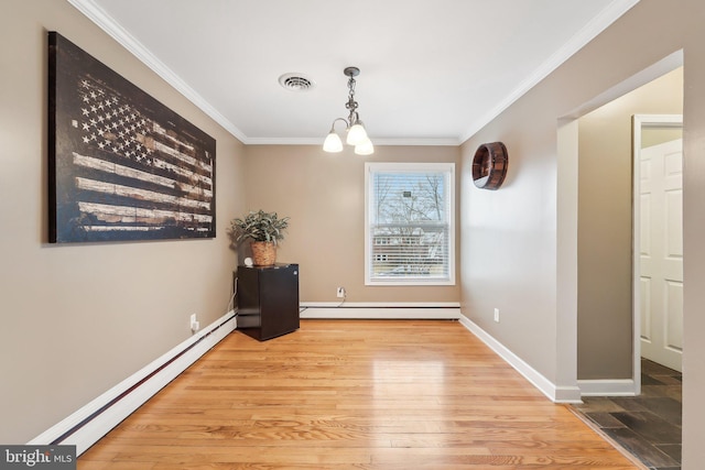 unfurnished dining area with crown molding, a baseboard heating unit, an inviting chandelier, and light hardwood / wood-style floors