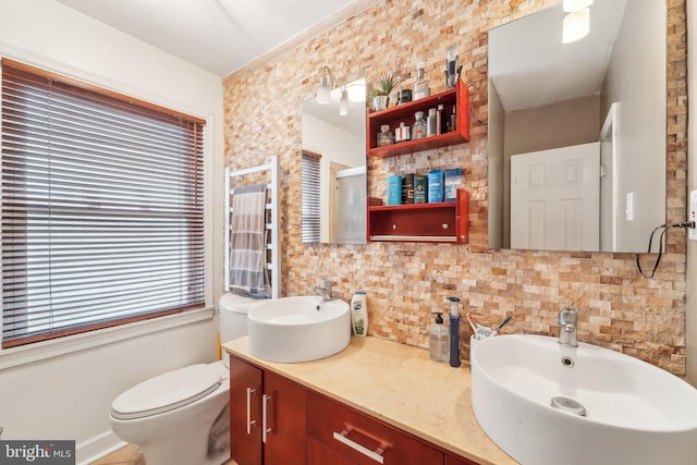 bathroom with vanity, backsplash, and toilet