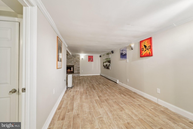 interior space with radiator heating unit, a fireplace, baseboard heating, and light hardwood / wood-style floors