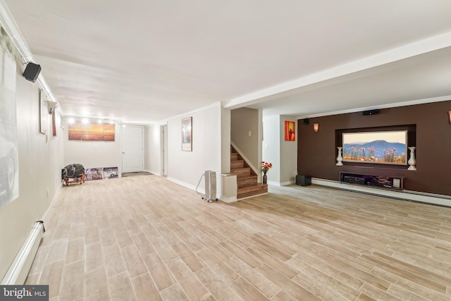 basement with a baseboard radiator and light wood-type flooring