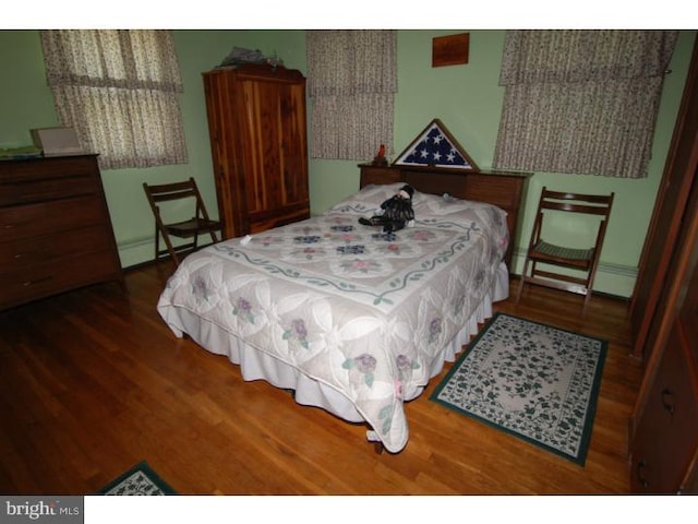 bedroom featuring dark hardwood / wood-style flooring and baseboard heating