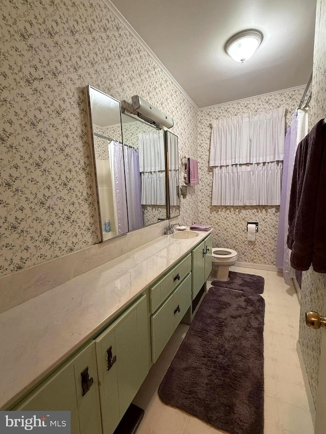 bathroom with toilet, crown molding, and vanity