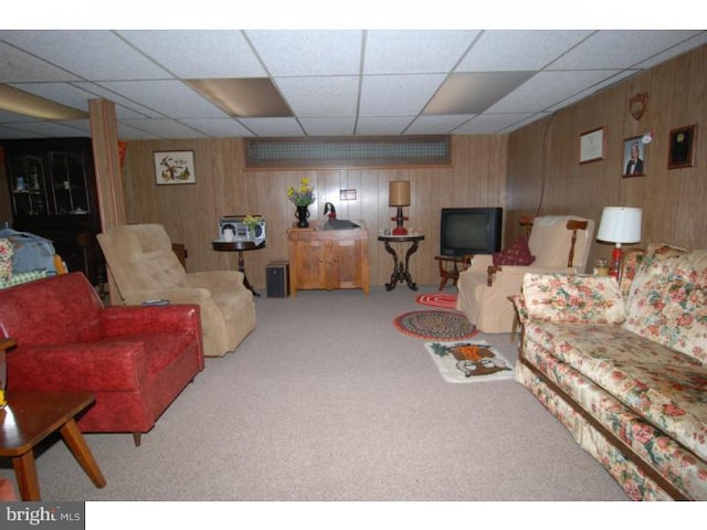 carpeted living room with wooden walls