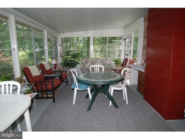 sunroom / solarium featuring a healthy amount of sunlight