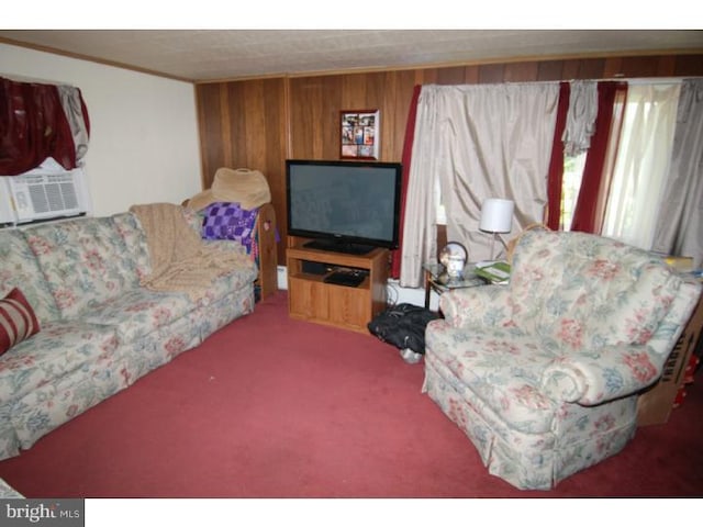 living room featuring crown molding, cooling unit, wood walls, and carpet