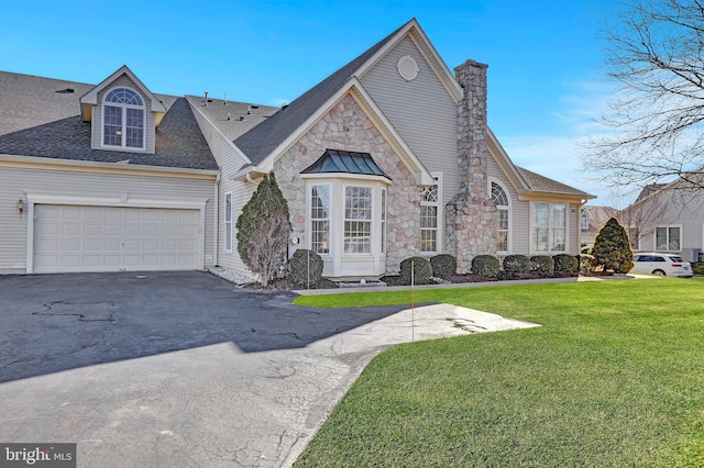 view of front of home featuring a garage and a front yard