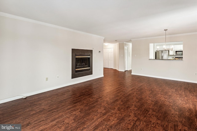 unfurnished living room featuring dark hardwood / wood-style floors and crown molding