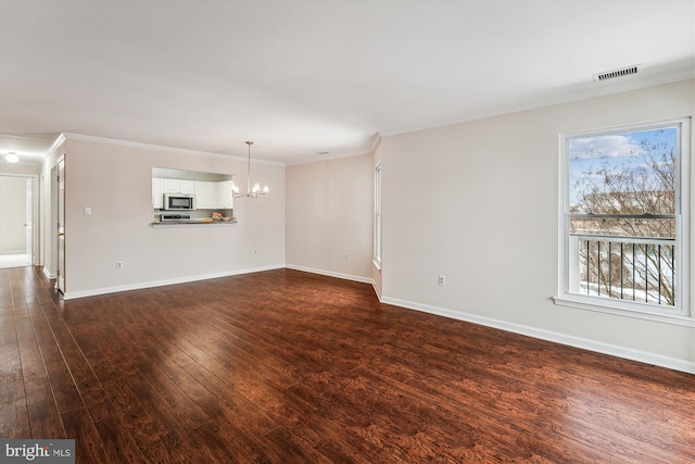 unfurnished living room featuring dark wood-type flooring, crown molding, and a notable chandelier