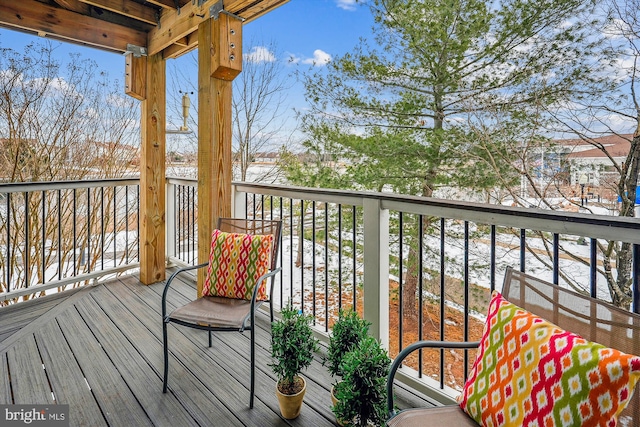 view of snow covered back of property