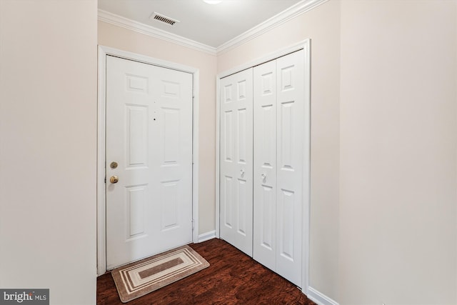 entryway with dark hardwood / wood-style floors and crown molding