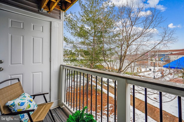 view of snow covered back of property